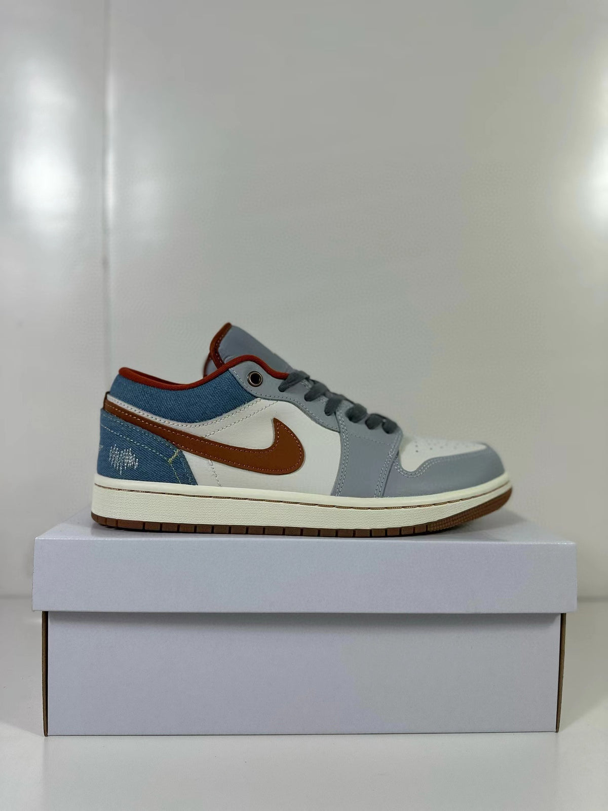 Side profile highlighting the contrasting upper panels and brown outsole