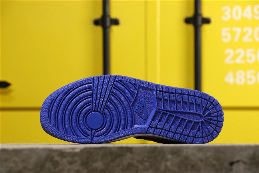 Underside view showing the blue rubber outsole with circular and patterned traction areas.