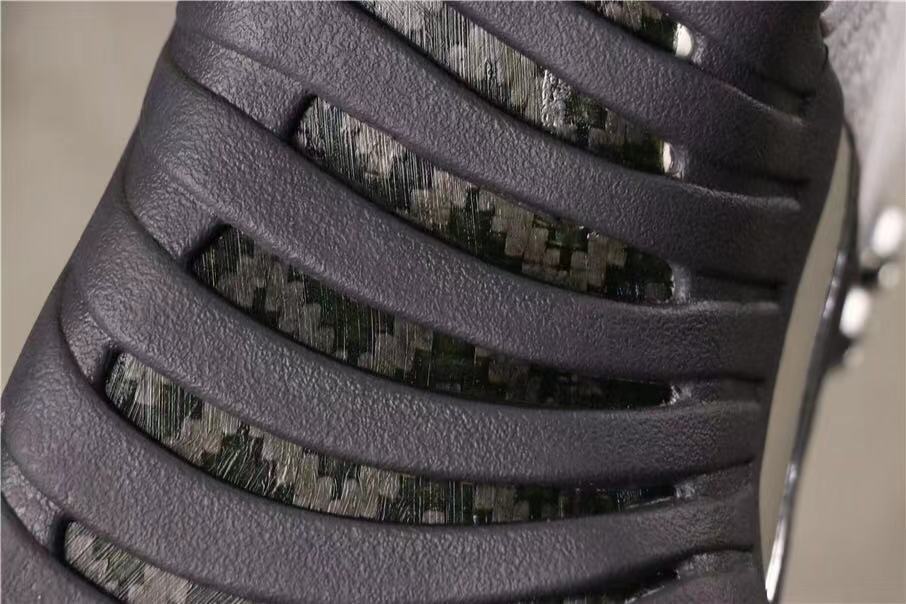 Close-up of the dark grey textured side panel and patterned underlay.