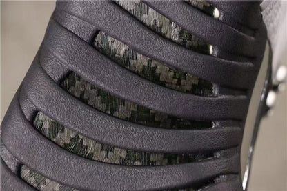 Close-up of the dark grey textured side panel and patterned underlay.