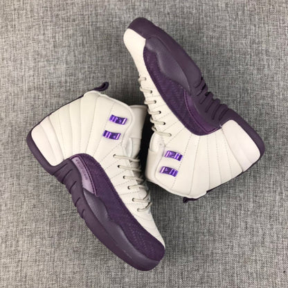 Pair of off-white and deep purple Air Jordan 12 high-top sneakers on a gray fabric surface