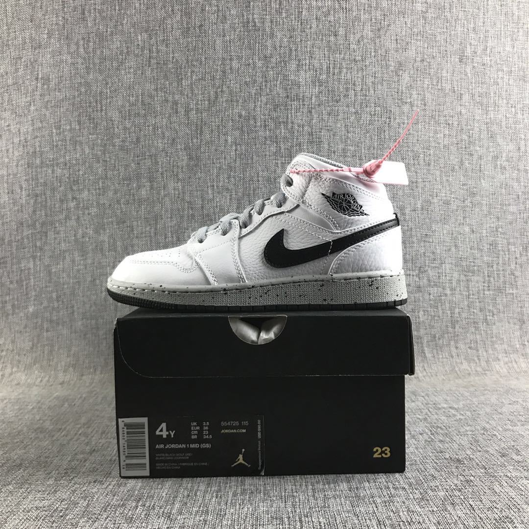 White and black high-top sneaker displayed on a black box; the box label shows Air Jordan 1 Mid (GS), EU 36, and US 4Y.