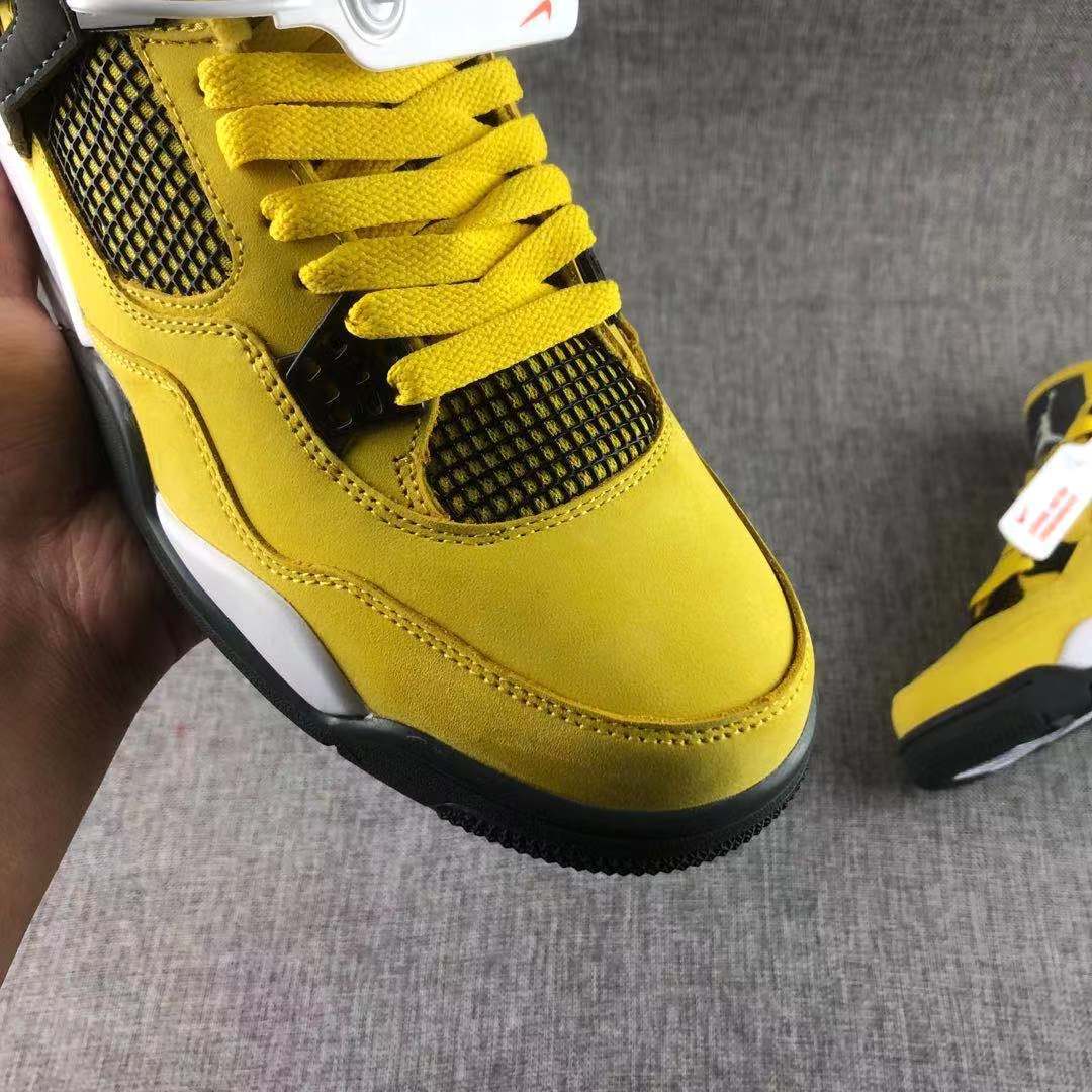 Top-front view showing the yellow laces, black mesh tongue area, and yellow toe section.