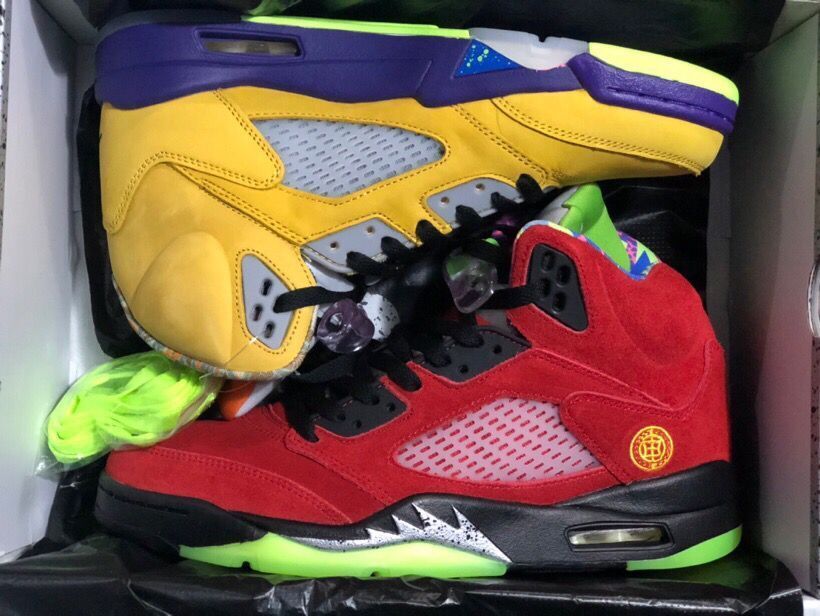 Yellow and red high-top sneakers displayed together inside a Jordan shoebox.