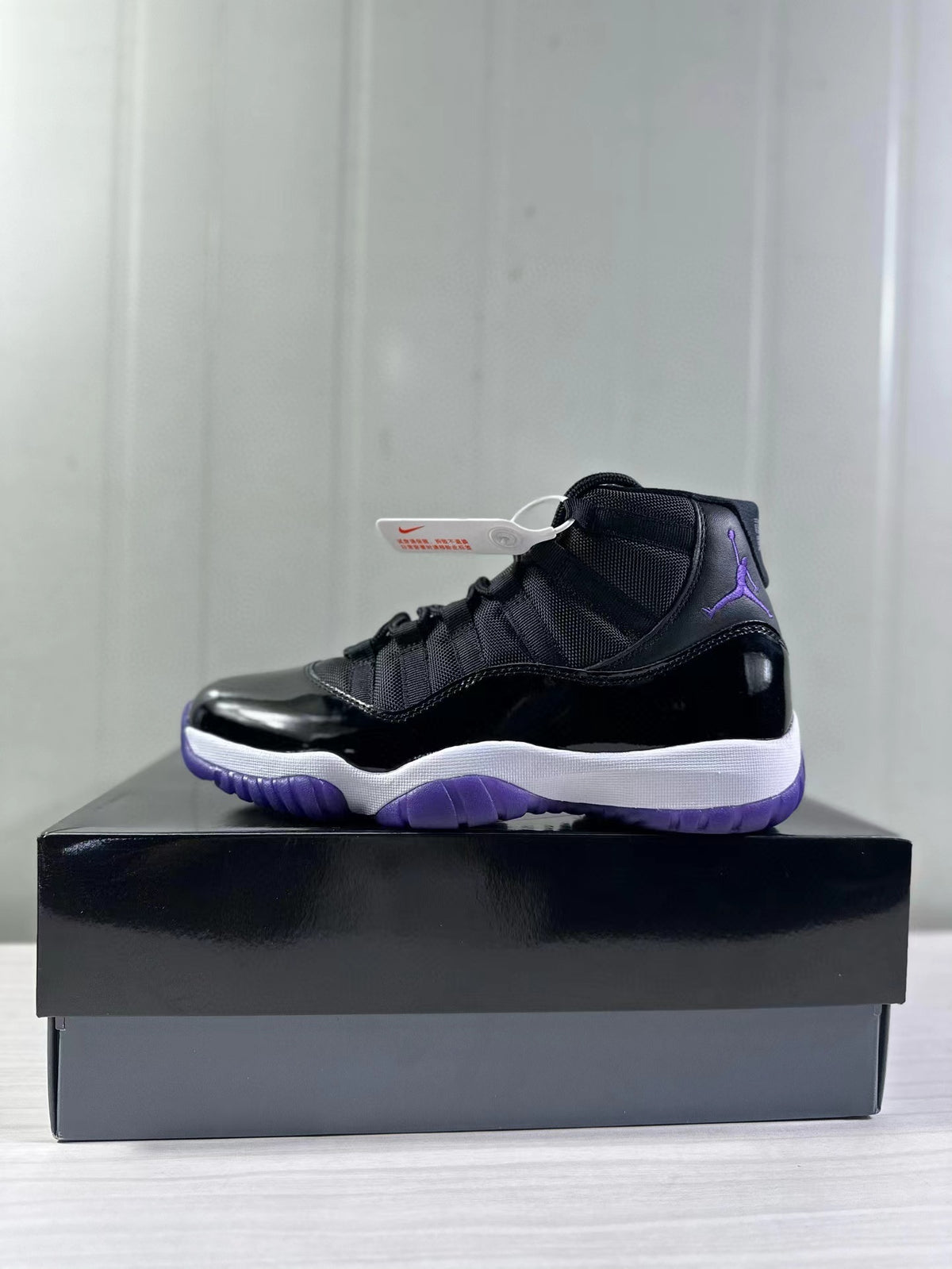 Side view highlighting the black upper, purple Jordan branding, white midsole, and purple outsole.