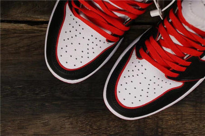 Close-up of the perforated white toe boxes with black overlays and red laces.