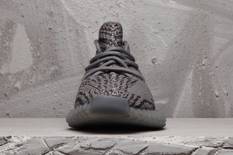 Front view showing the patterned knit-style upper, laces and rounded toe.