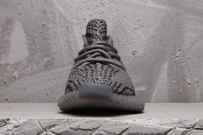 Front view showing the patterned knit-style upper, laces and rounded toe.