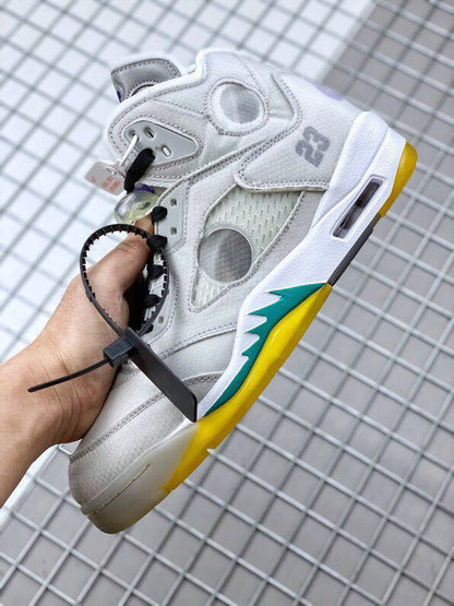 Side view showing the circular translucent panel, grey overlays, printed number detail, and yellow-teal outsole accents.