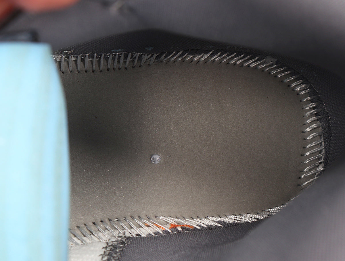 Close-up of the sneaker interior showing the dark insole and stitched collar lining.