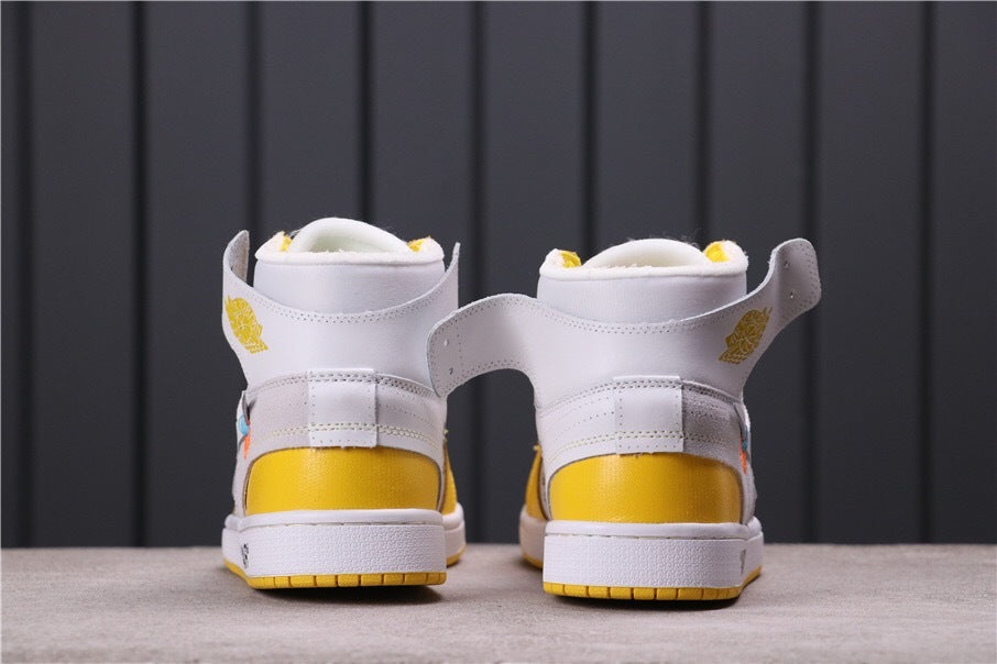Rear view showing white ankle collars, yellow heel panels, and white midsoles.