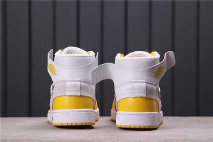 Rear view showing white ankle collars, yellow heel panels, and white midsoles.