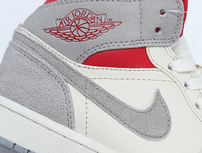 Close-up of the grey and white sneaker upper with a grey Swoosh, red panel and Air Jordan Wings branding.