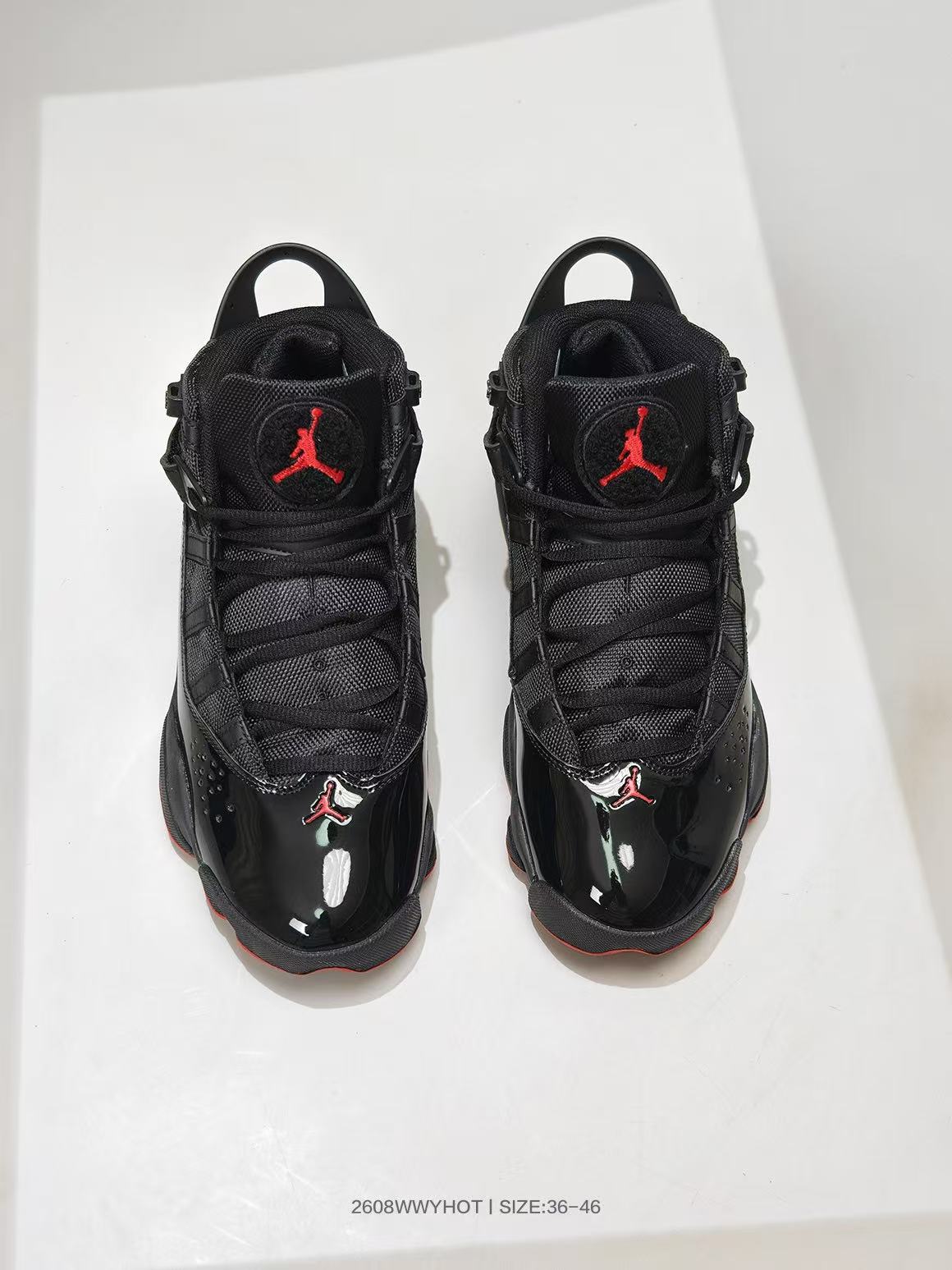 Pair of black and red Jordan 6 Rings-style high-top sneakers viewed from above, with size range text shown at the bottom.