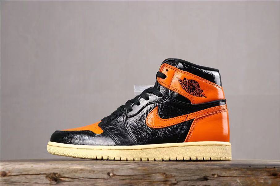 Opposite side profile showing the black and orange upper, orange Swoosh, collar branding, and cream-colored outsole.
