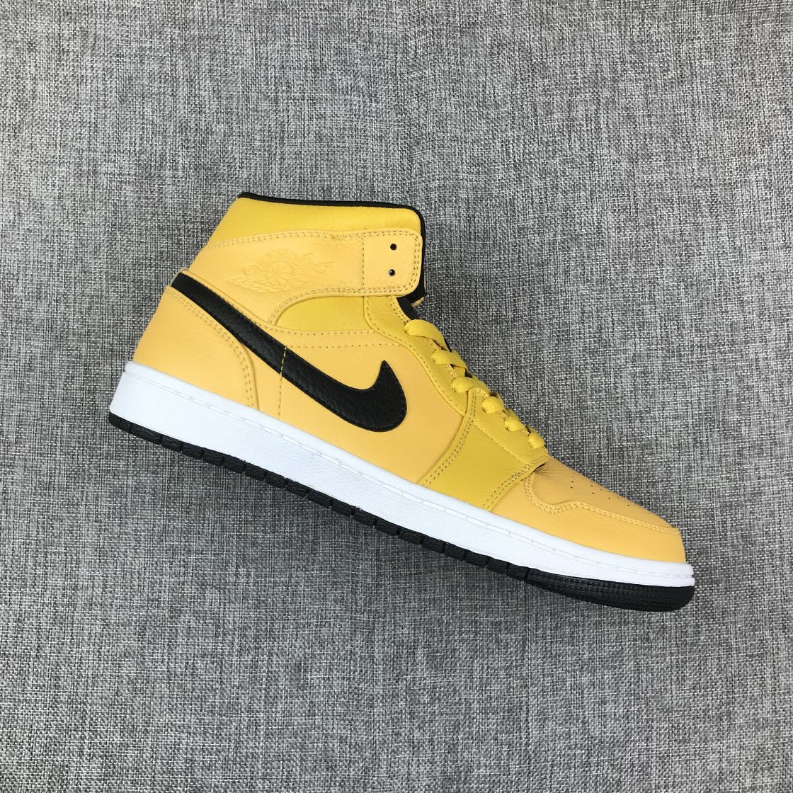 Single yellow and black mid-top sneaker shown from an elevated side angle.