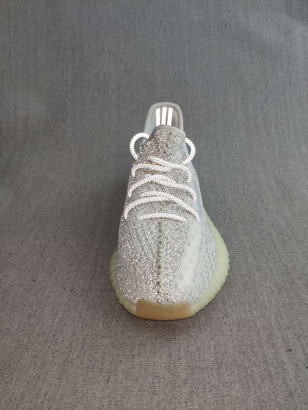 Front view showing the white laces and silver knit-style upper.