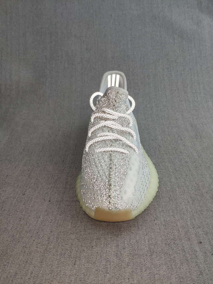 Front view showing the white laces and silver knit-style upper.