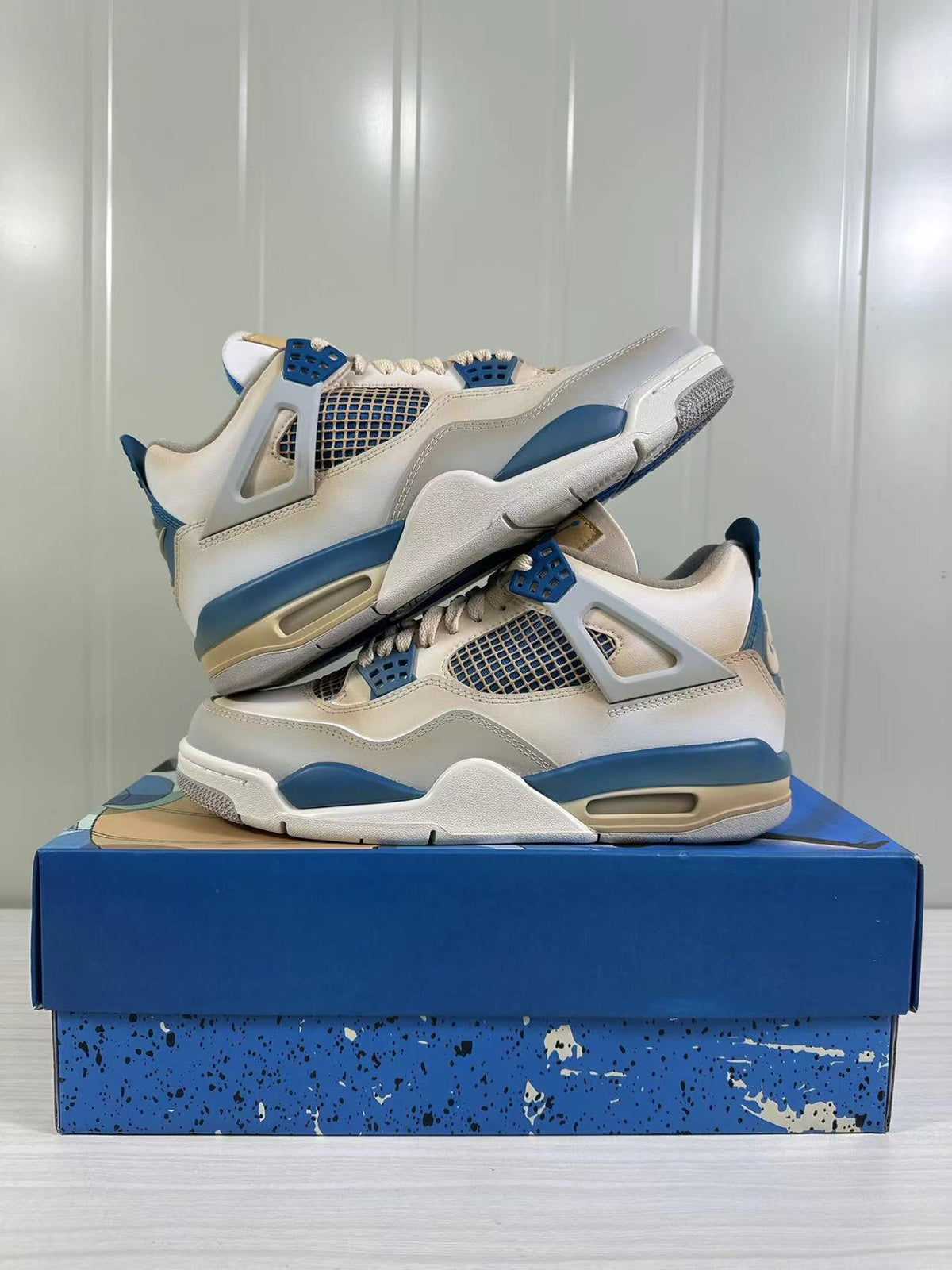 The two sneakers arranged one above the other to show their side profiles and blue accents.