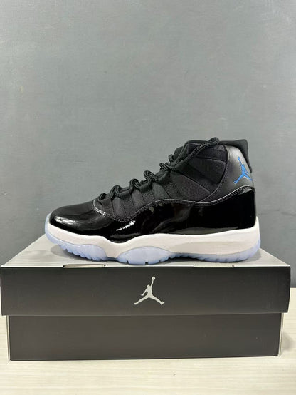 Side profile of a black and blue high-top sneaker with blue Jumpman branding and a white midsole on a shoebox.