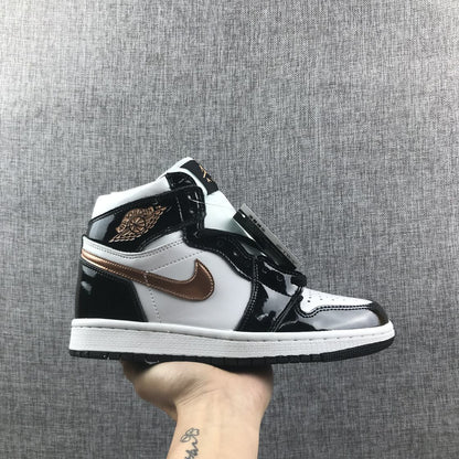 Side view of a black, white and metallic-gold Air Jordan 1 Mid sneaker held against a gray fabric background.