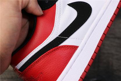 Close-up of the black Swoosh, white side panel, red heel panel, and white midsole.