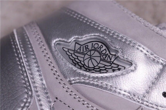 Close-up of the silver Air Jordan wing logo and stitched high-top upper.