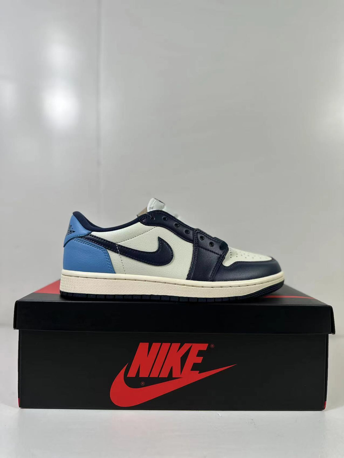 Side profile showing the low-top shape, dark Swoosh, blue heel panel, and off-white midsole.