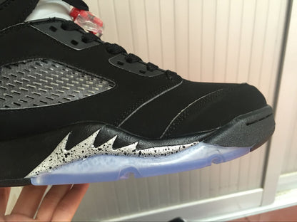 Close-up of the black toe and side area with silver speckled detailing above the translucent outsole.