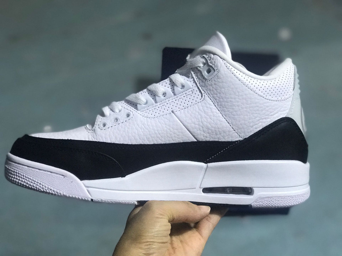 Side profile showing the white upper, black overlays, and white sole.