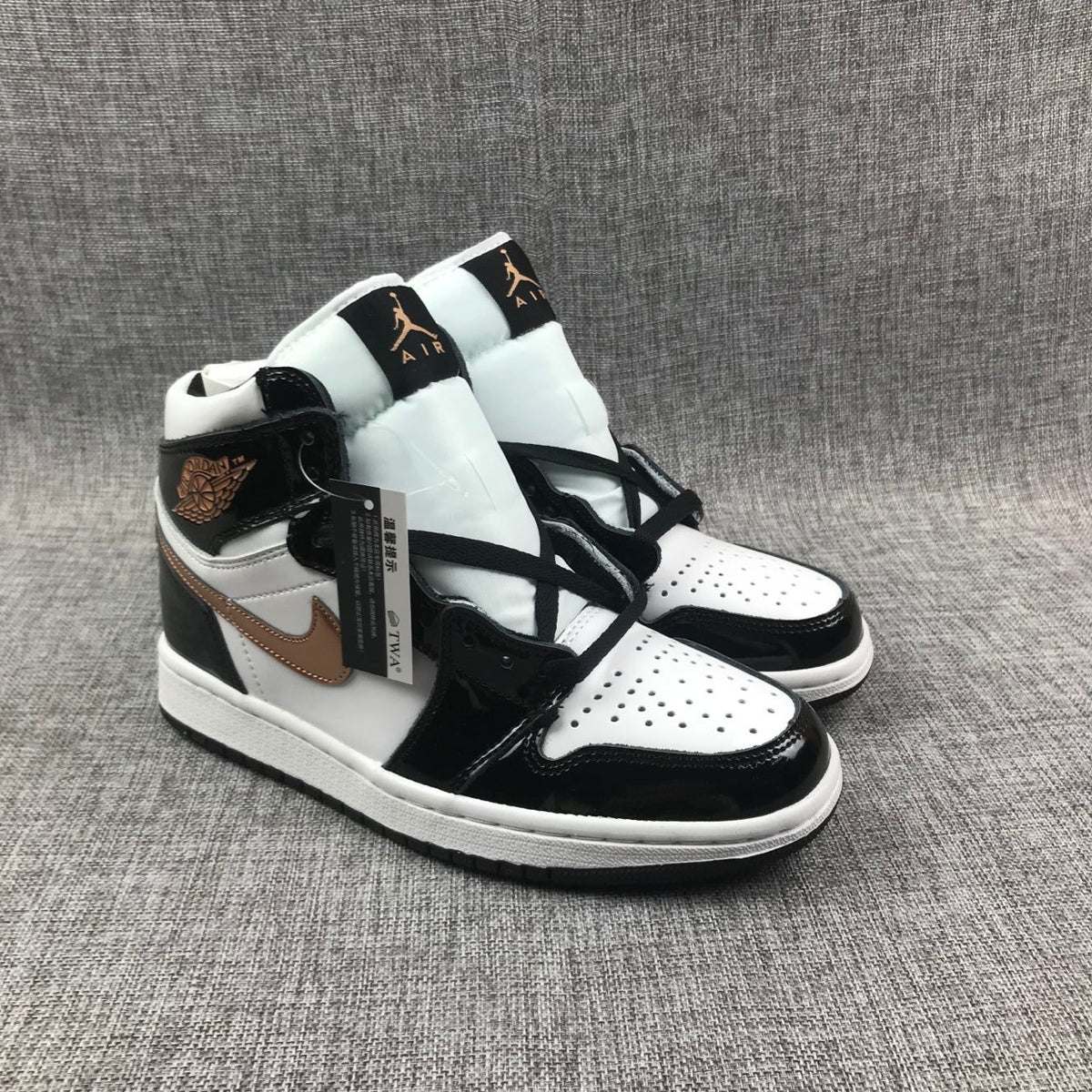 Front three-quarter view of the pair with white perforated toe boxes and black laces.