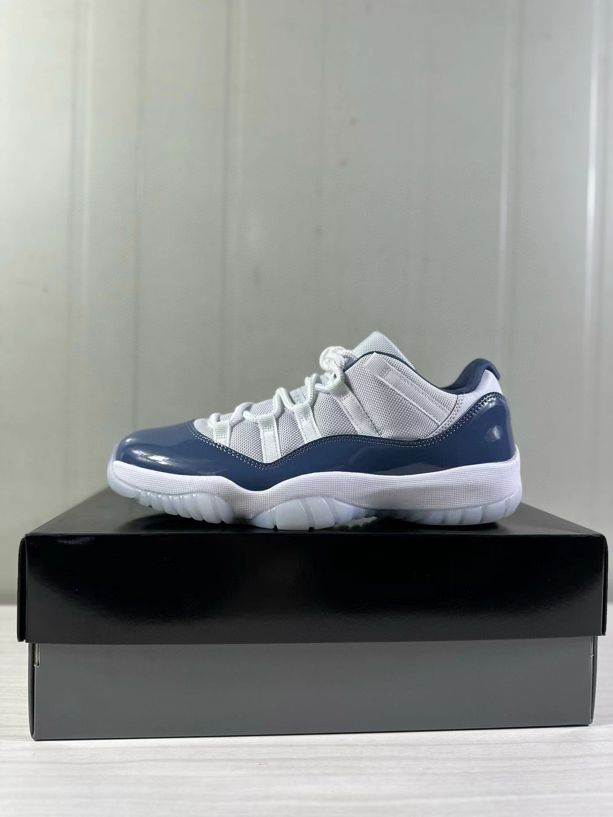 Side profile of a white and blue Jordan Air Jordan 11 Low sneaker