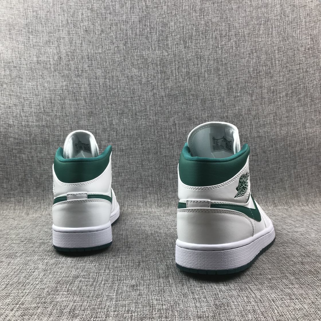 Rear view of both sneakers showing the green collars and white heels.