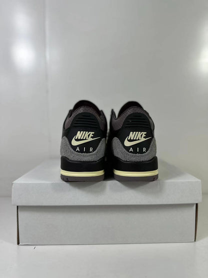 Rear view showing Nike Air branding, gray heel overlays, black heel panels, and cream midsole accents.