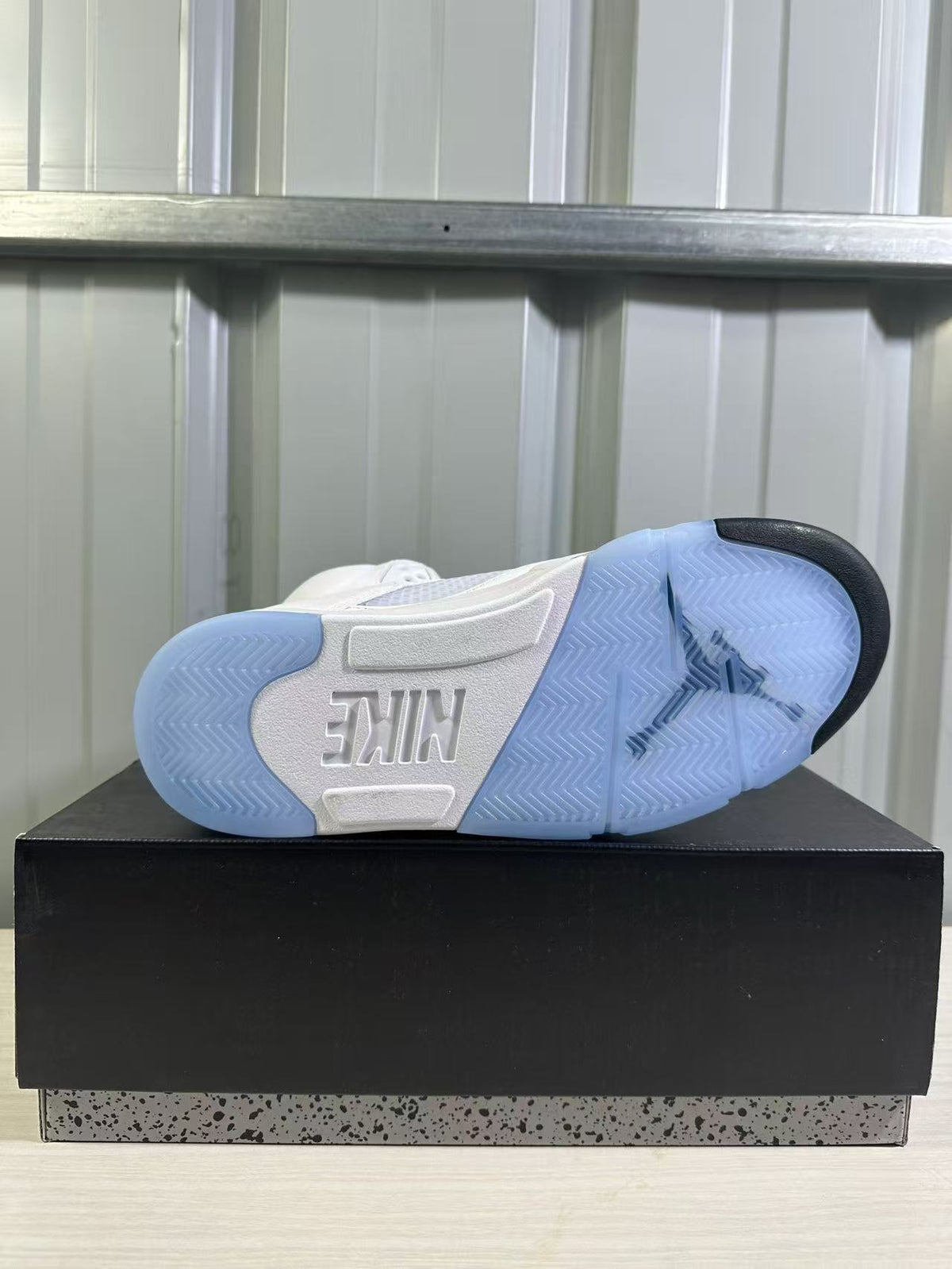 Outsole view showing translucent blue sections, black traction accents, and Nike branding.