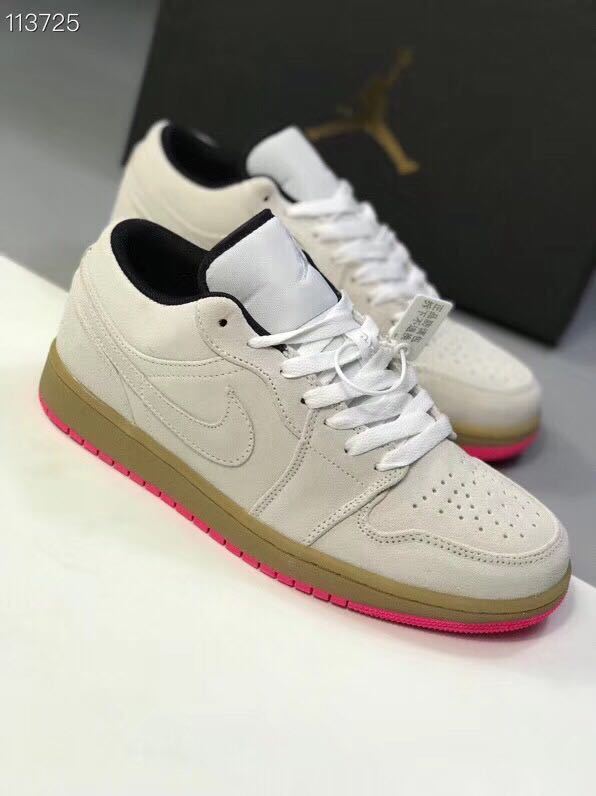 Angled view of the gray and white low-top sneakers showing the side Swoosh and pink outsole.