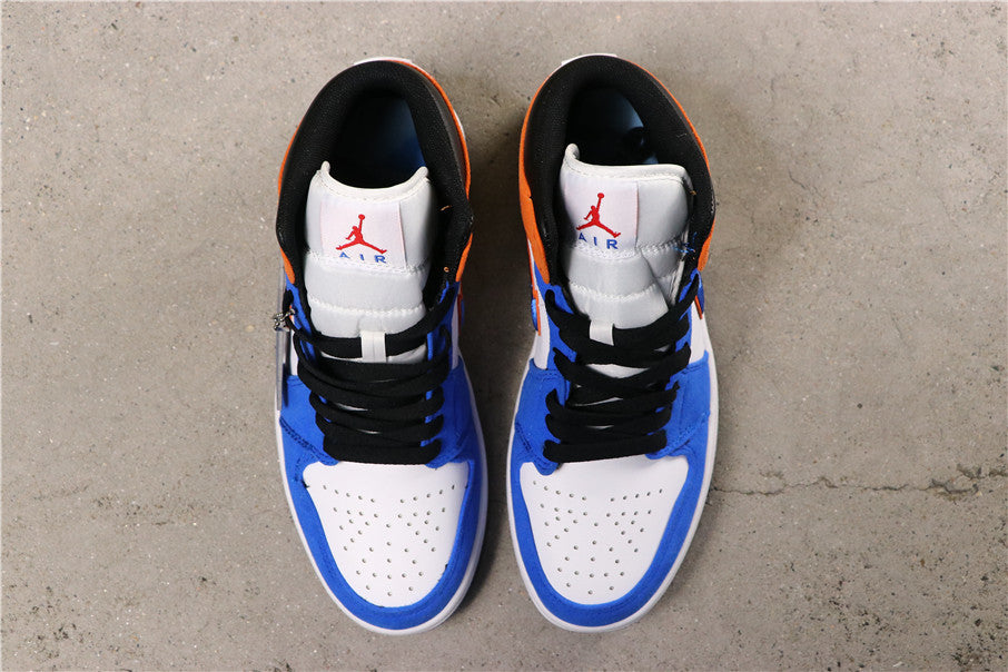 Top view of the blue, white and black mid-top sneakers with orange details, black laces and perforated toe boxes.
