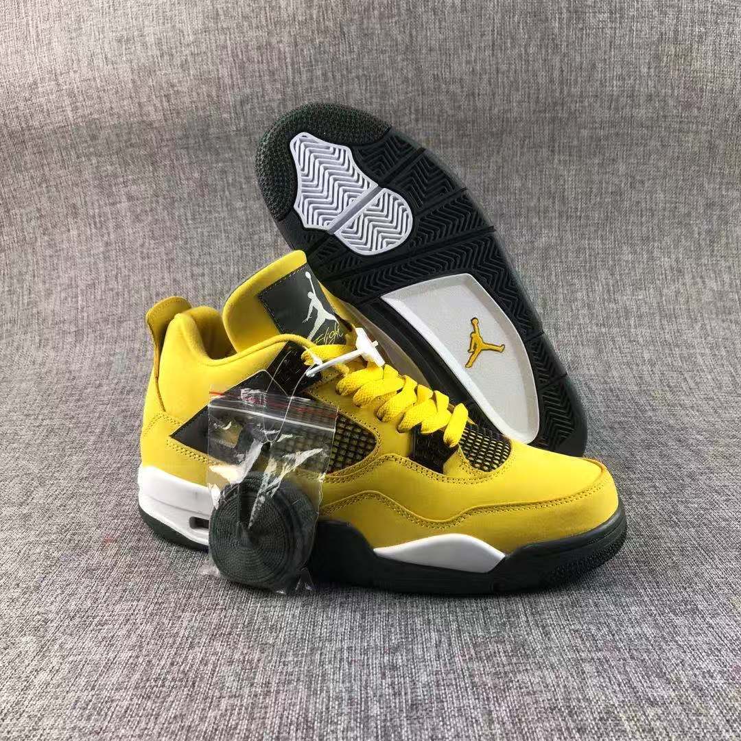 Pair of yellow and black high-top sneakers displayed with an extra lace bundle and a visible outsole.