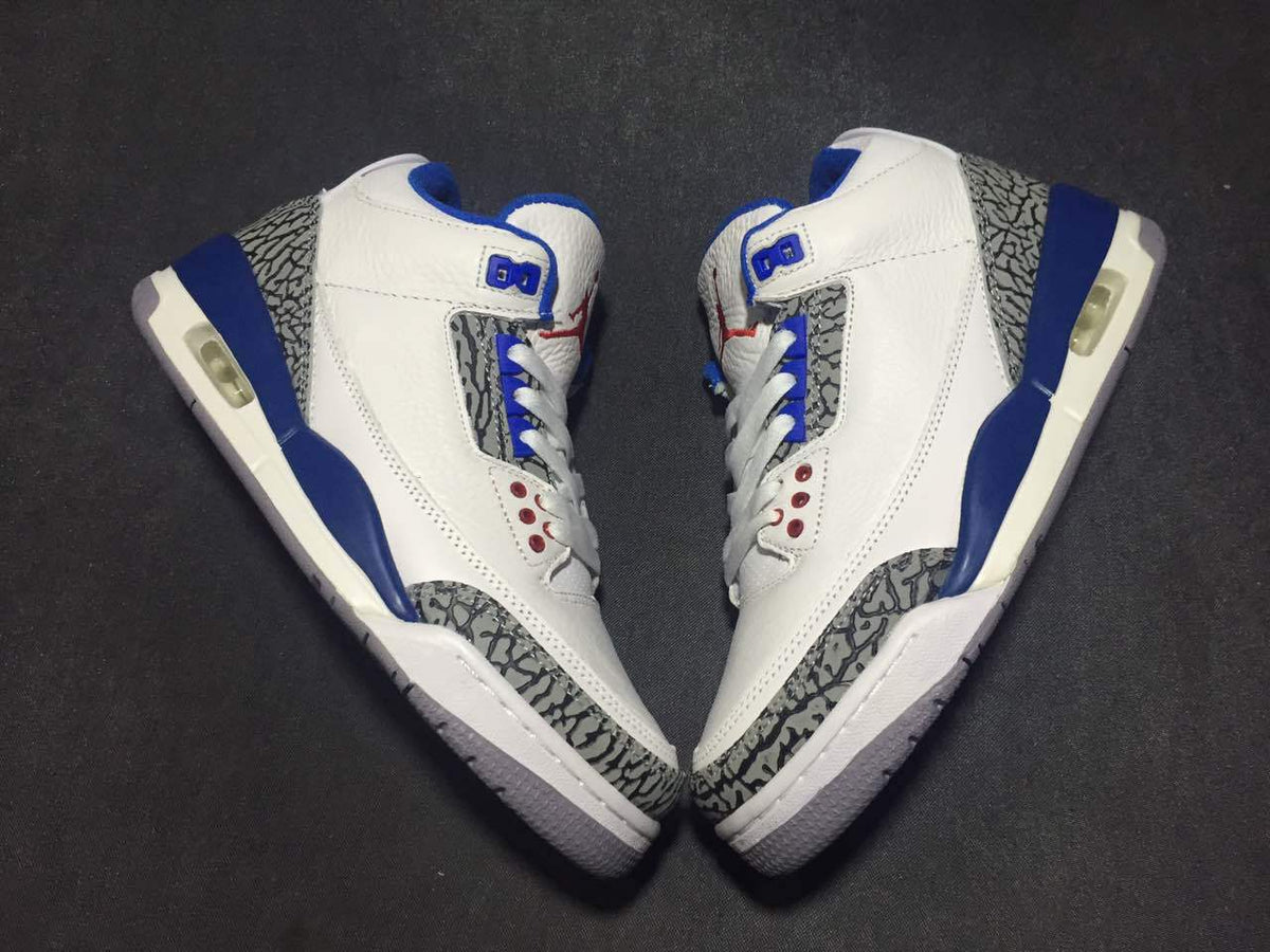 Top-down view of the pair arranged toe-to-toe, showing the white and blue colorway and elephant-print panels.
