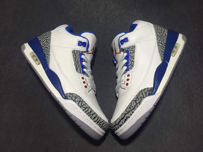 Top-down view of the pair arranged toe-to-toe, showing the white and blue colorway and elephant-print panels.
