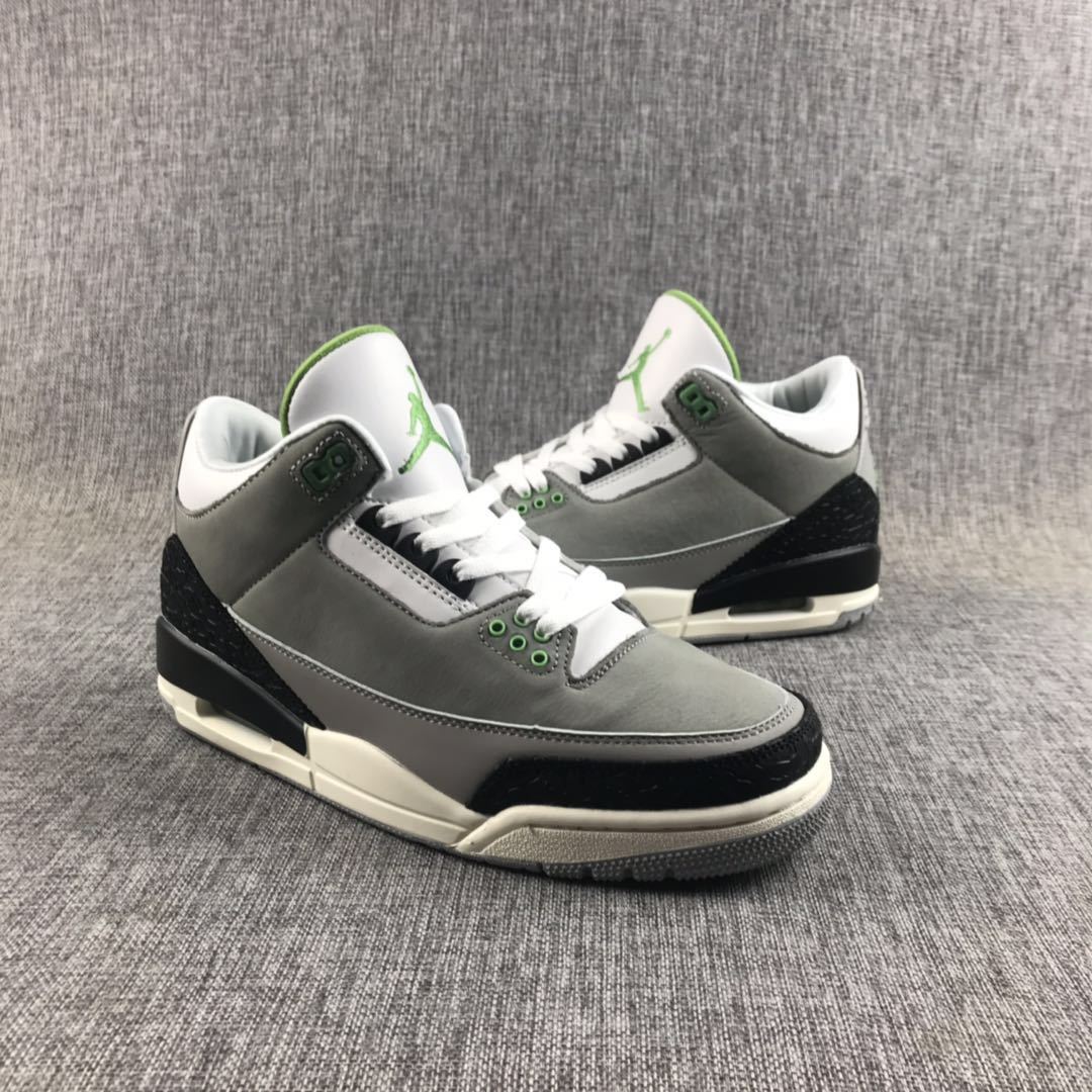 Pair of gray Jordan Air Jordan 3 sneakers shown from a front three-quarter angle with black, white, and green details.