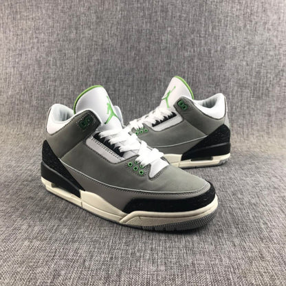 Pair of gray Jordan Air Jordan 3 sneakers shown from a front three-quarter angle with black, white, and green details.
