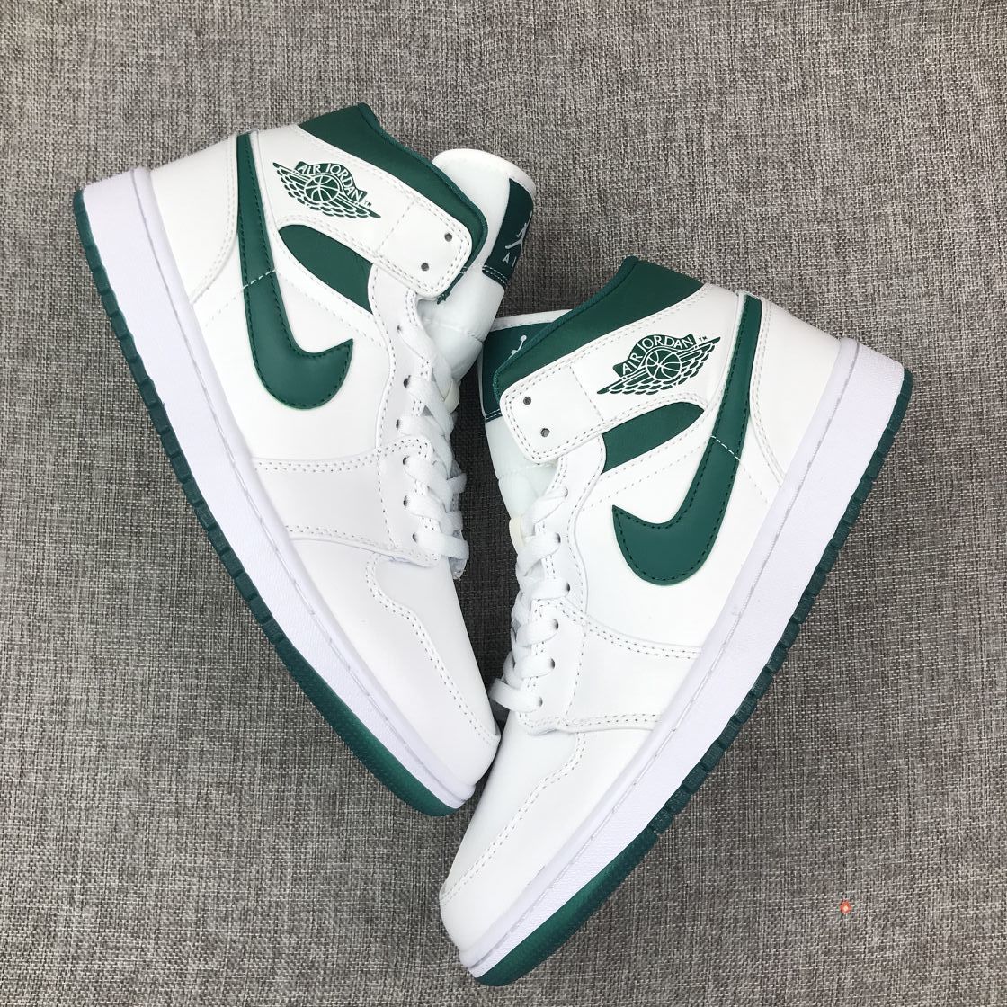 Top-down view of the pair displaying the mid-top shape and green accents.
