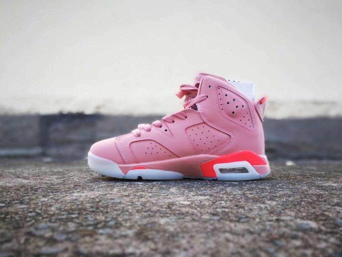 Opposite side view of the pink Air Jordan 6 high-top sneaker showing its laces, perforated upper, and heel cushioning window.
