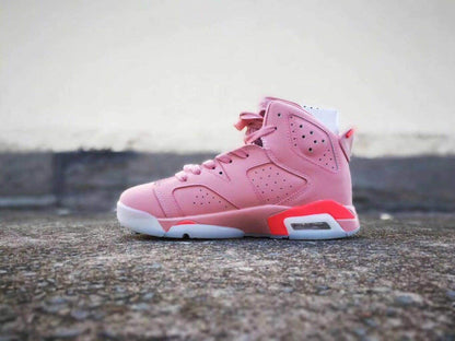 Opposite side view of the pink Air Jordan 6 high-top sneaker showing its laces, perforated upper, and heel cushioning window.