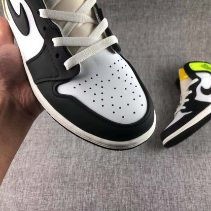 Close-up of the white perforated toe box, black overlay and white laces.
