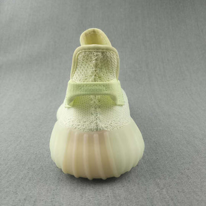 Rear view showing the padded heel area, rear pull tab, and ribbed pale yellow sole.