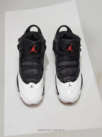 Top view of black, white, and red high-top sneakers with Jordan logos on the tongues.