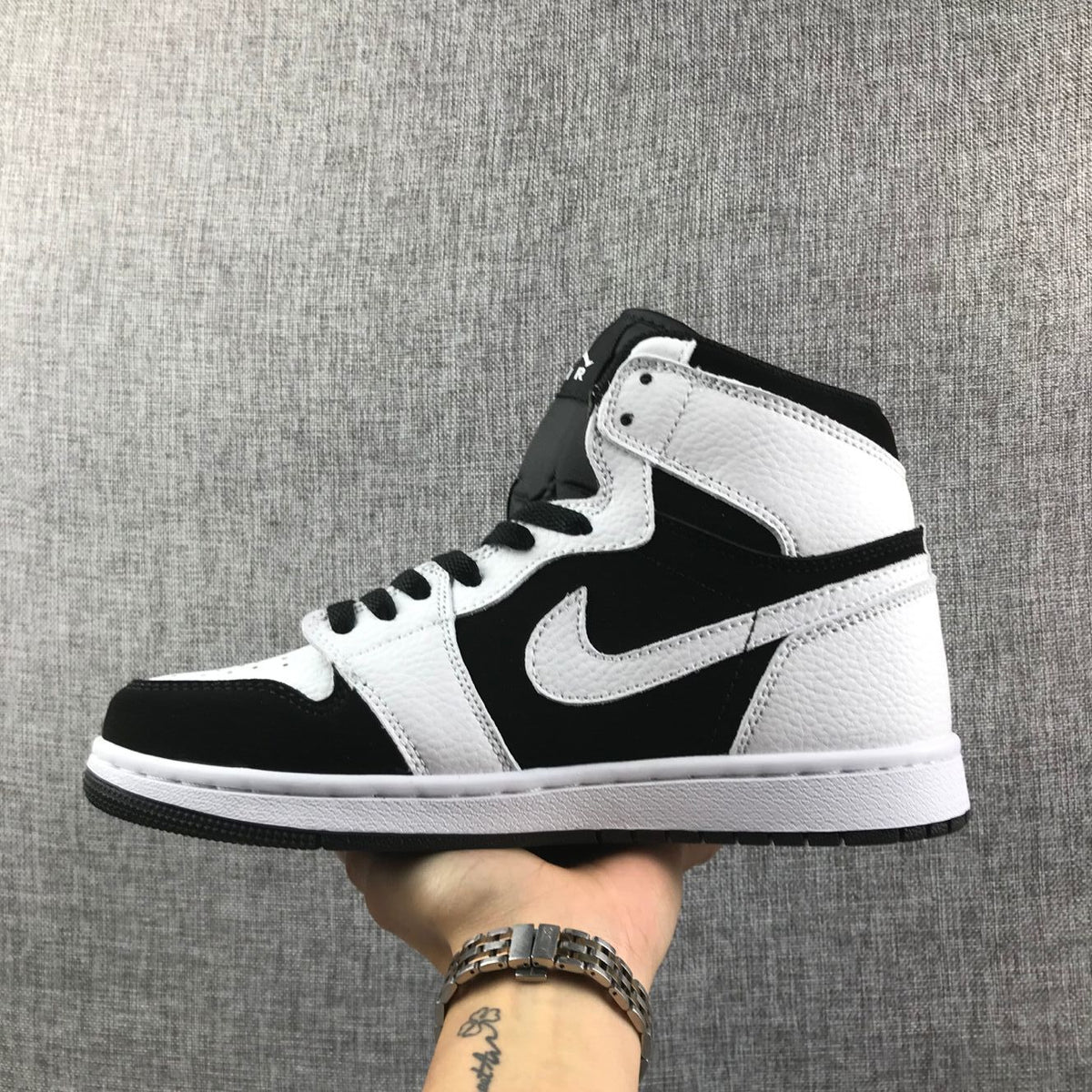 Side profile of the black-and-white high-top sneaker