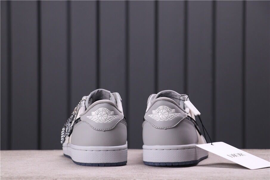 Rear view of the pair showing grey heel panels, white midsoles and dark translucent outsole edges.